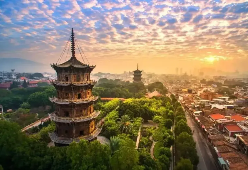 Kaiyuan Temple Quanzhou twin pagodas at sunrise - UNESCO World Heritage stone architecture with intricate carvings